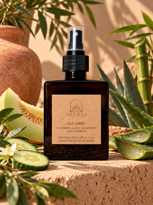 Aromas Aztecas Aguamiel room and linen spray surrounded by cucumber, aloe, honeydew, agave, and bamboo in a warm sunlit setting.